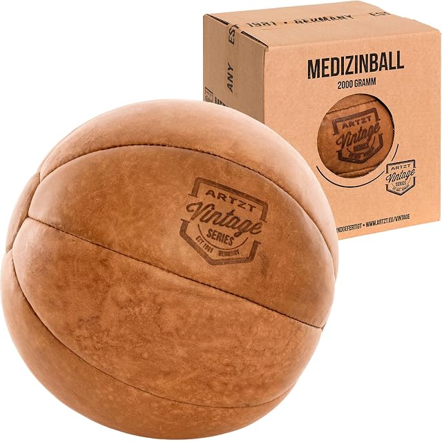 Balón medicinal ARTZT Vintage Series de piel color tostado con un escudo grabado a fuego, junto a una caja de cartón que dice 2000 GRAMM
